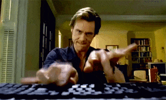 Jim Carey in Bruce Almighty mashing away at a keyboard