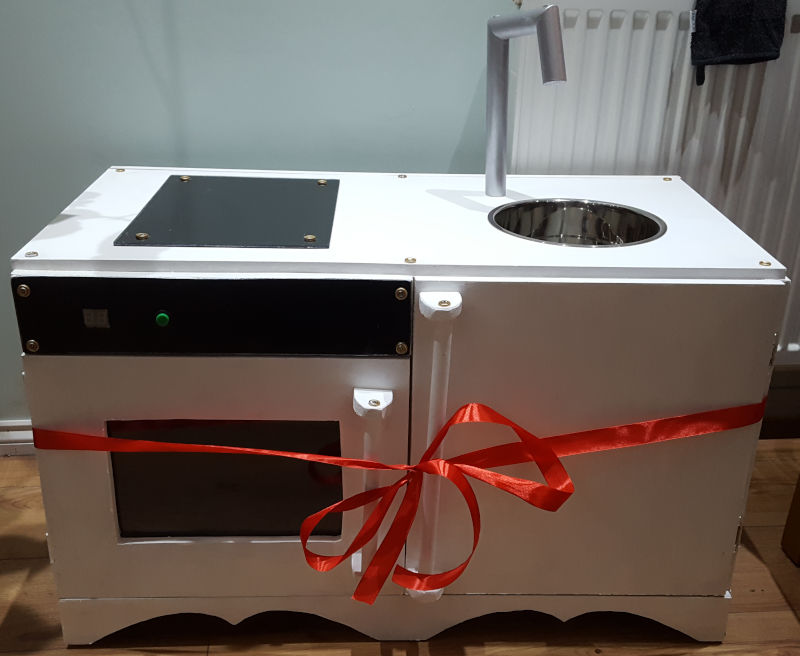 The finished kitchen with added hob, interactive faceplate, and silver wooden tap